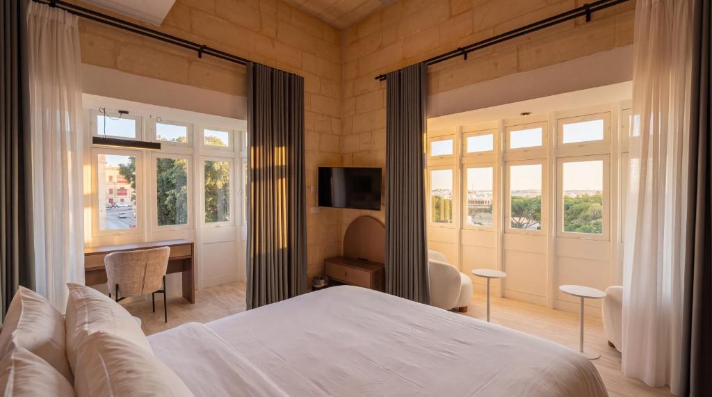 Suite with an armchair and panoramic windows at St Anne Palace, Floriana, Malta